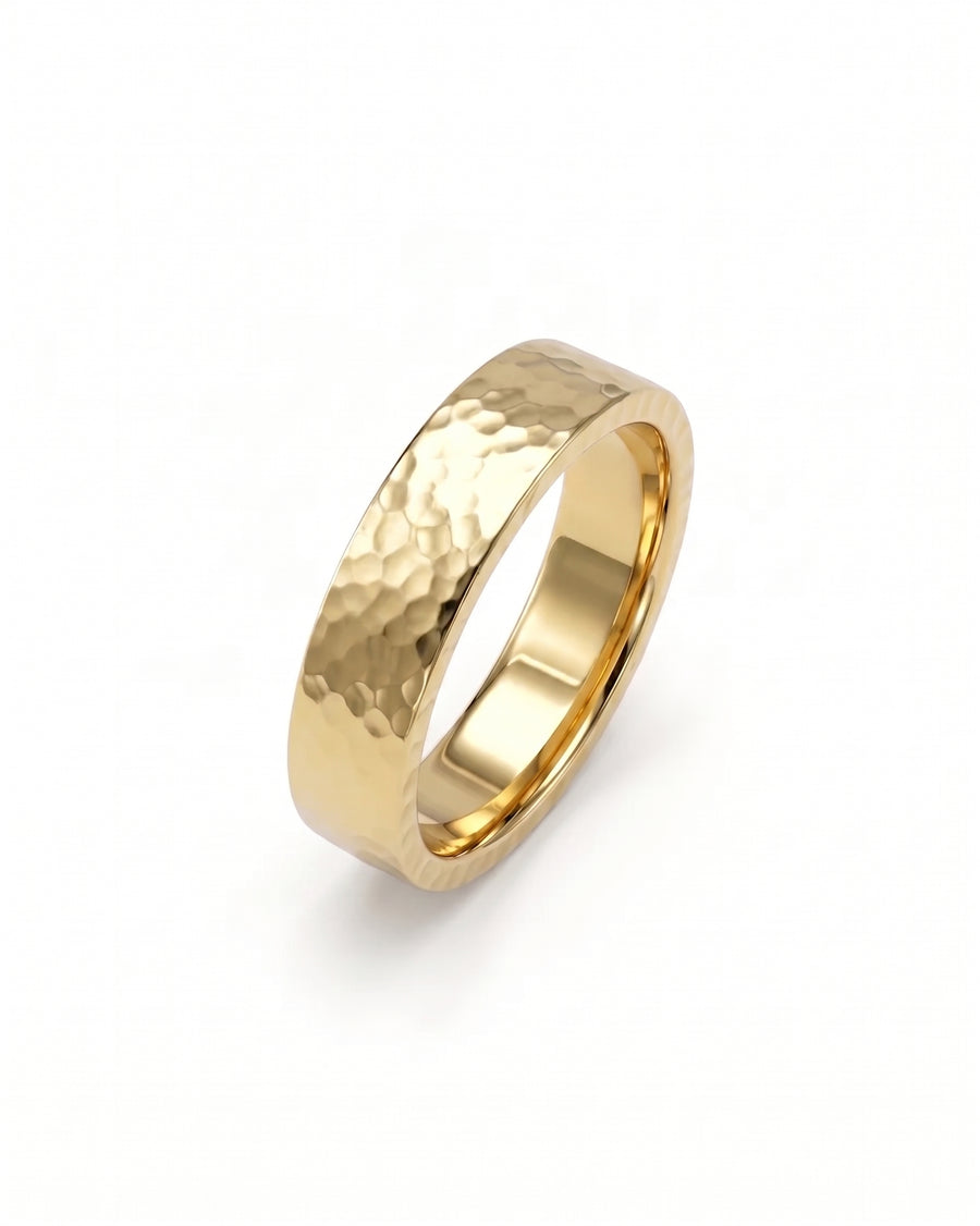 Flat gold wedding ring with a hammered texture finish on a white background.