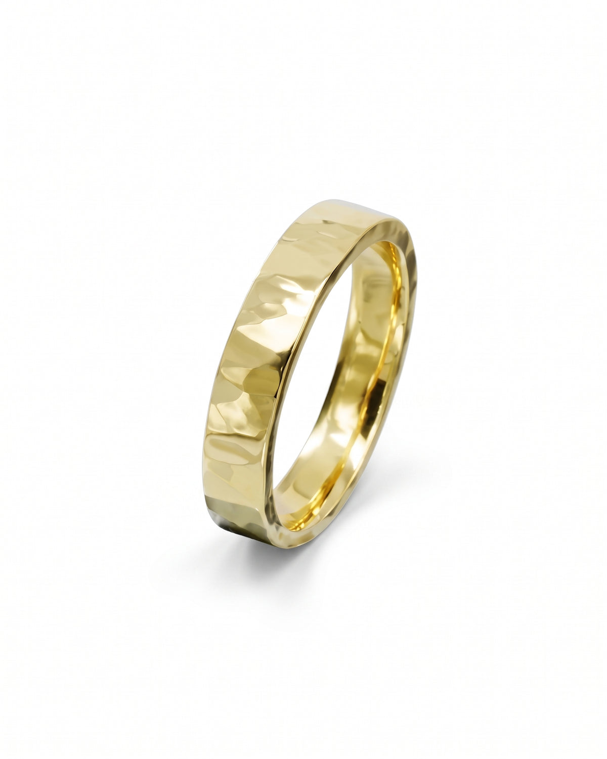 Gold wedding band with a hammered texture and polished finish isolated on a white background.