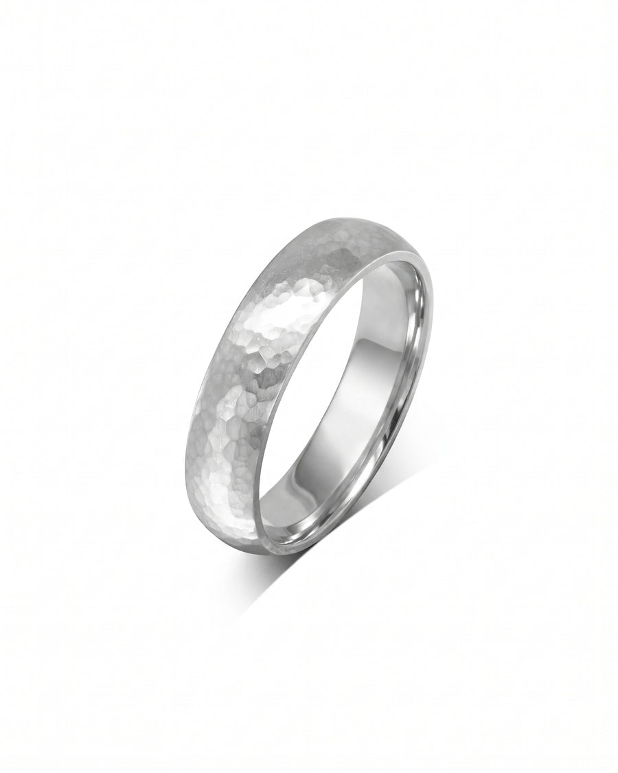 Silver-toned metal wedding ring with a matte hammered texture and a smooth, polished inner band.