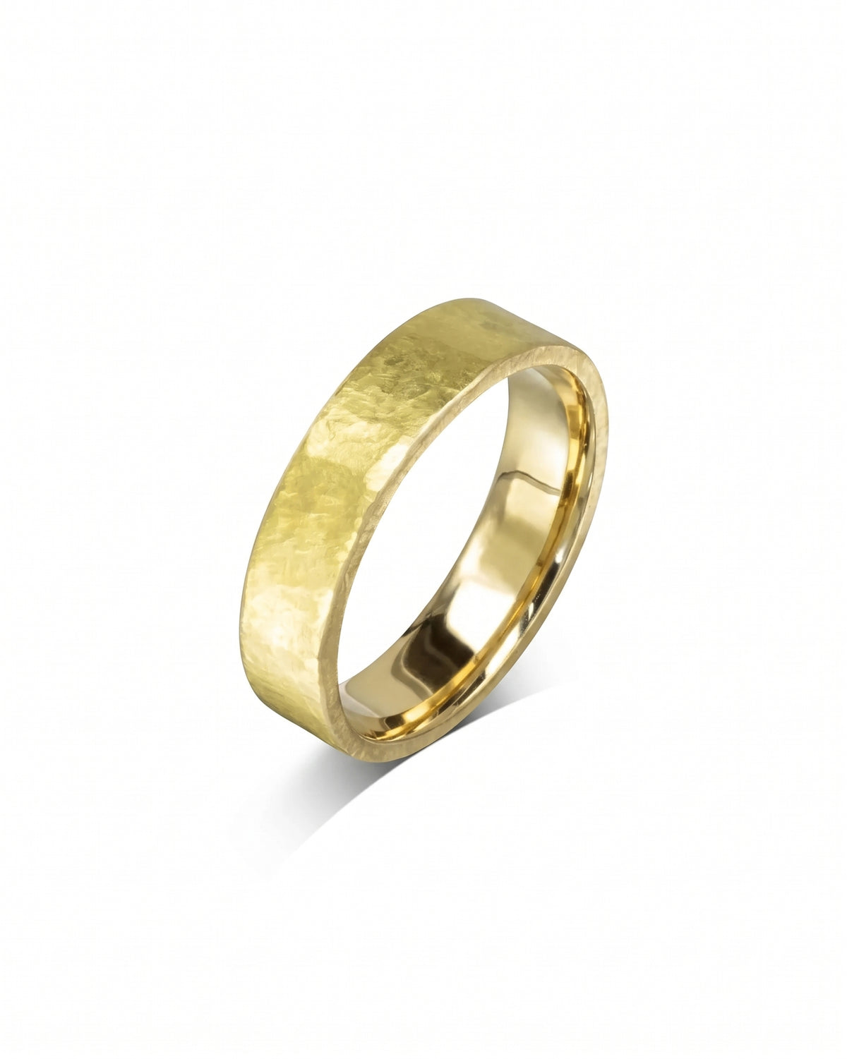 Yellow gold wedding band featuring a textured, rough hammered finish on a polished flat surface.