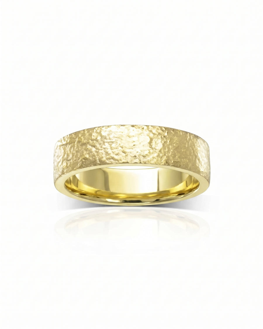 Yellow gold wedding ring with a textured, hammered finish and a smooth polished interior band.