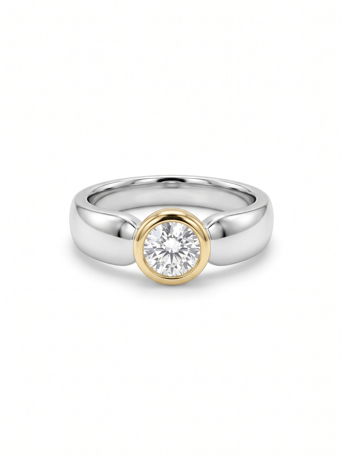 Round diamond ring in a gold bezel setting on a polished silver band.