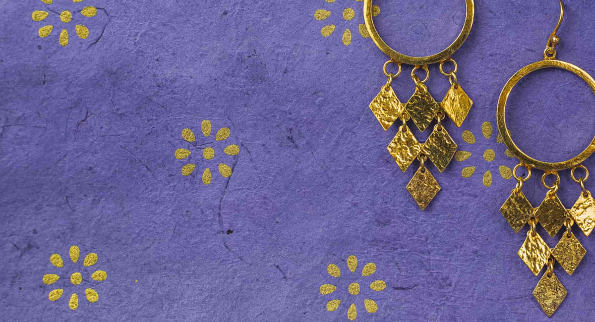 Purple background with gold earrings