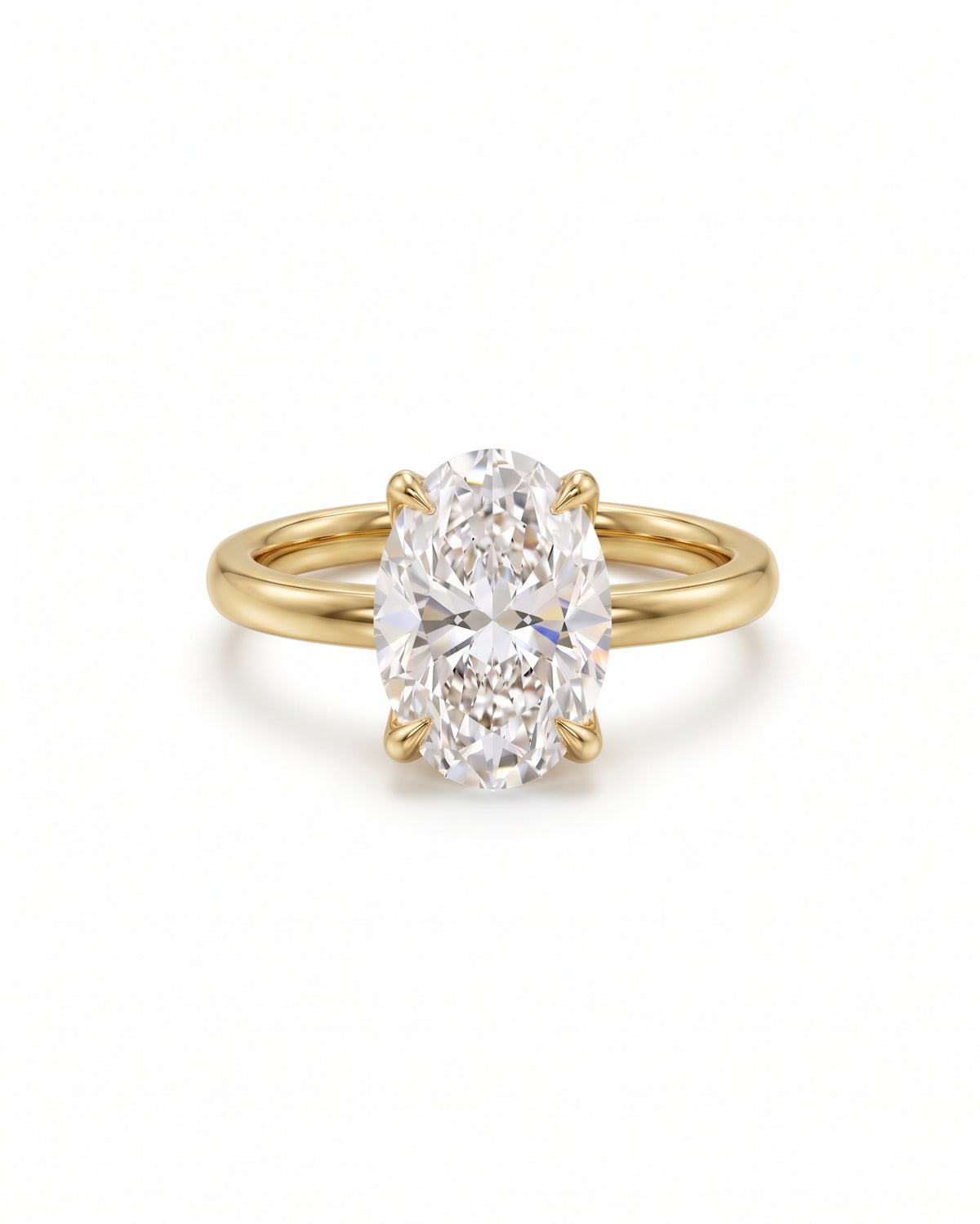 Oval solitaire engagement ring with a clear gemstone set in a polished yellow gold band.
