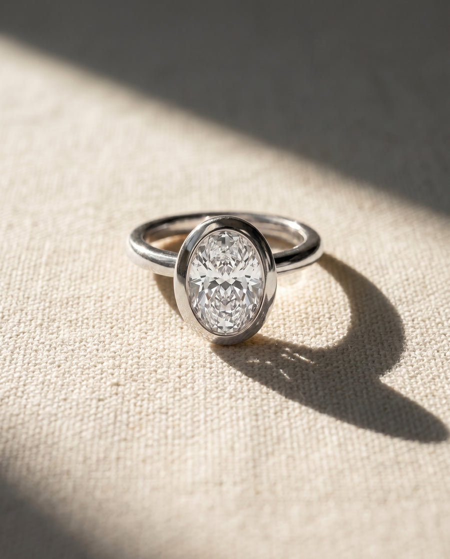 Oval Cut Bezel Cathedral Engagement Ring