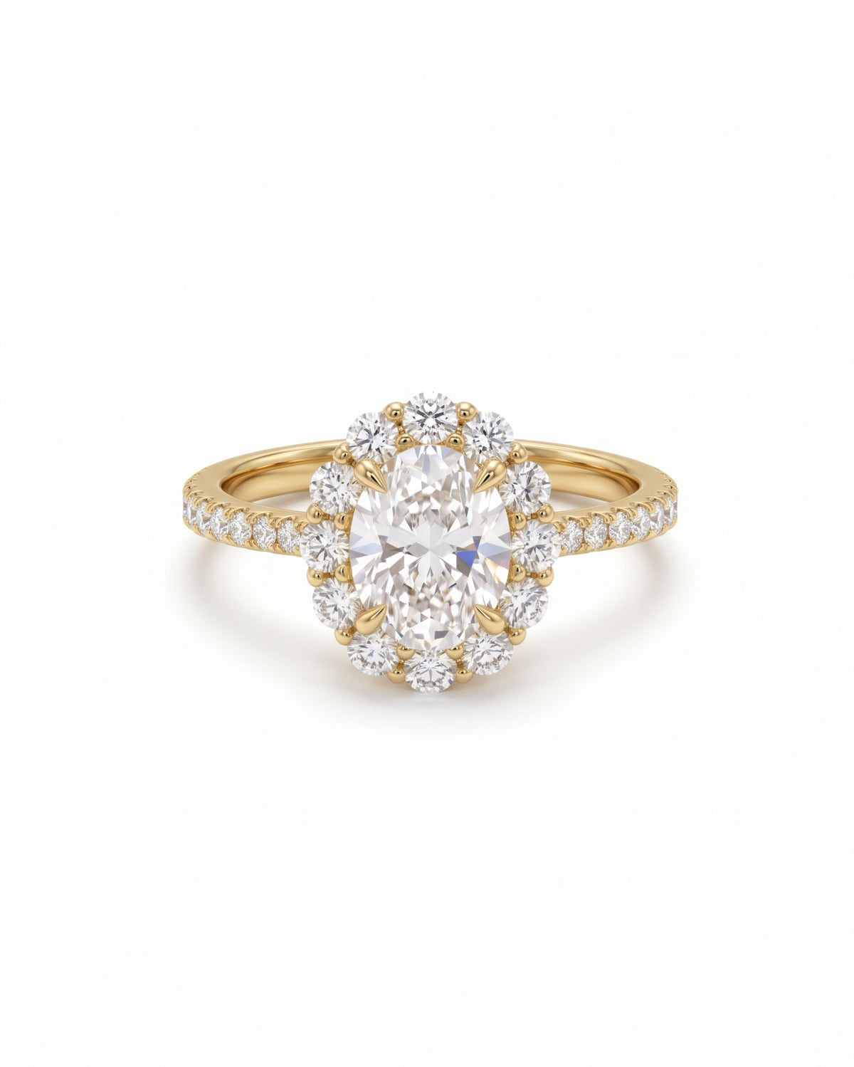 Oval cut diamond halo ring in yellow gold with claw settings and a pavé band.