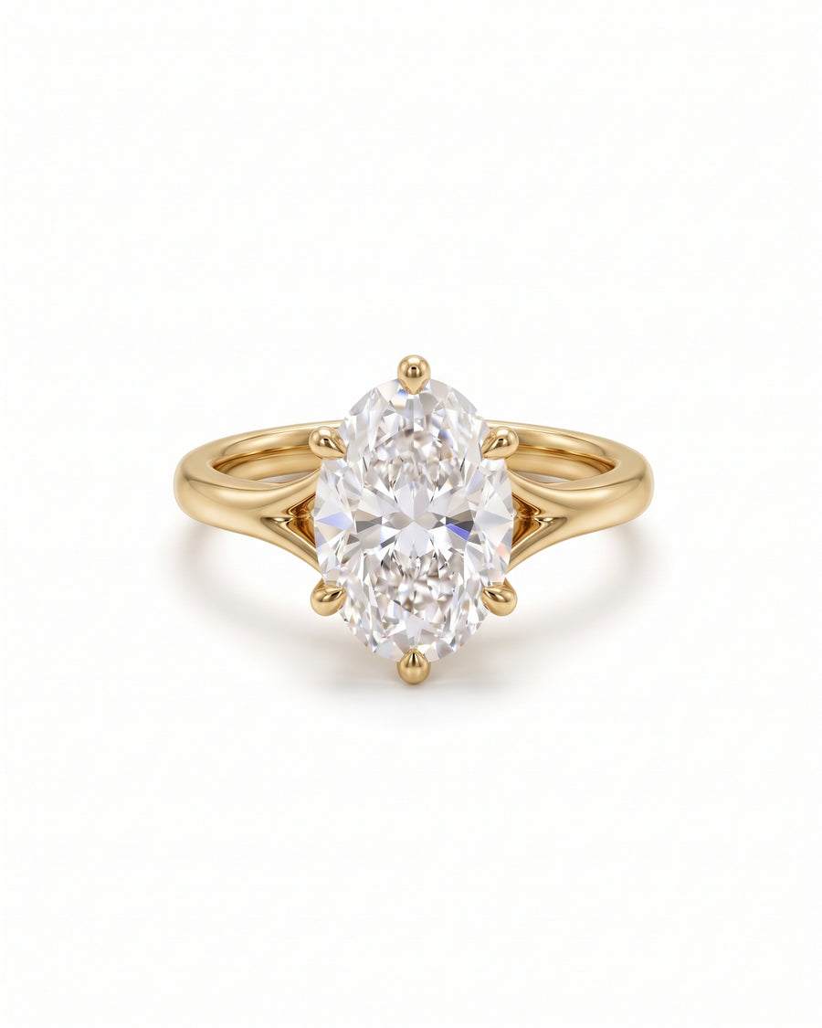 Oval cut diamond engagement ring set in a yellow gold tulip claw setting on a plain band.