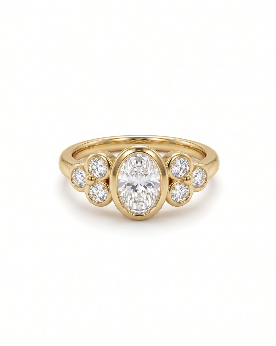 Gold oval trefoil engagement ring featuring a central oval diamond flanked by clusters of round diamonds.