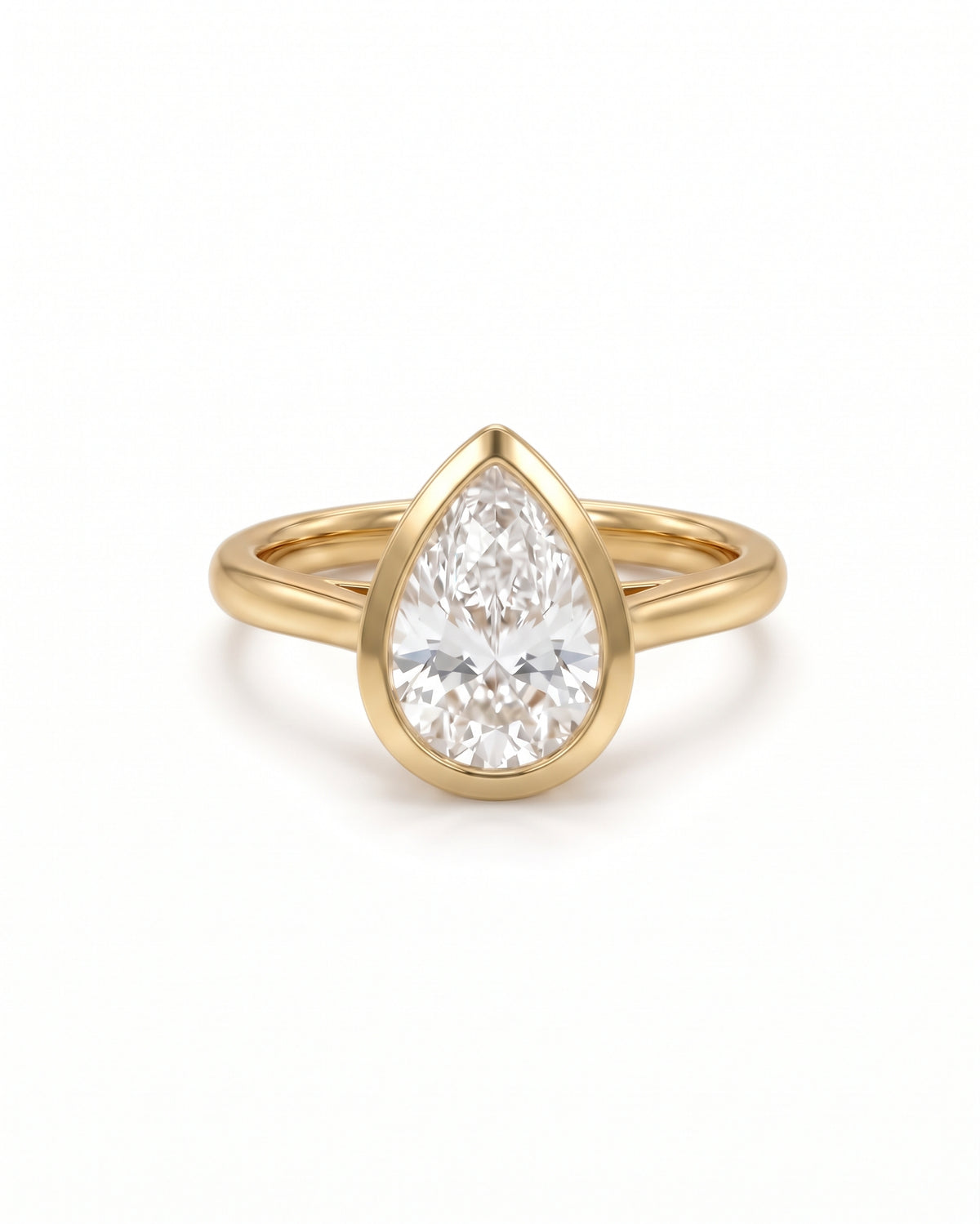 Pear cut diamond engagement ring in 18ct yellow gold with a smooth bezel setting.