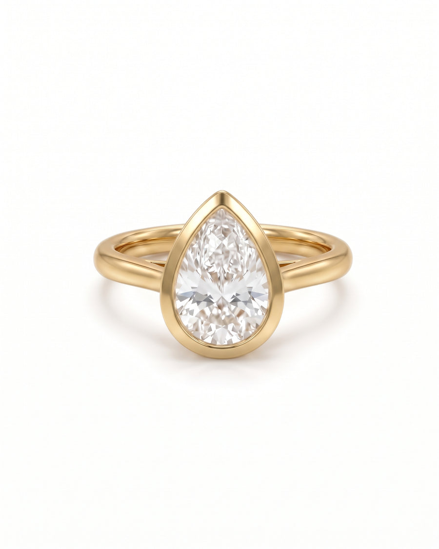Pear cut diamond engagement ring in 18ct yellow gold with a smooth bezel setting.