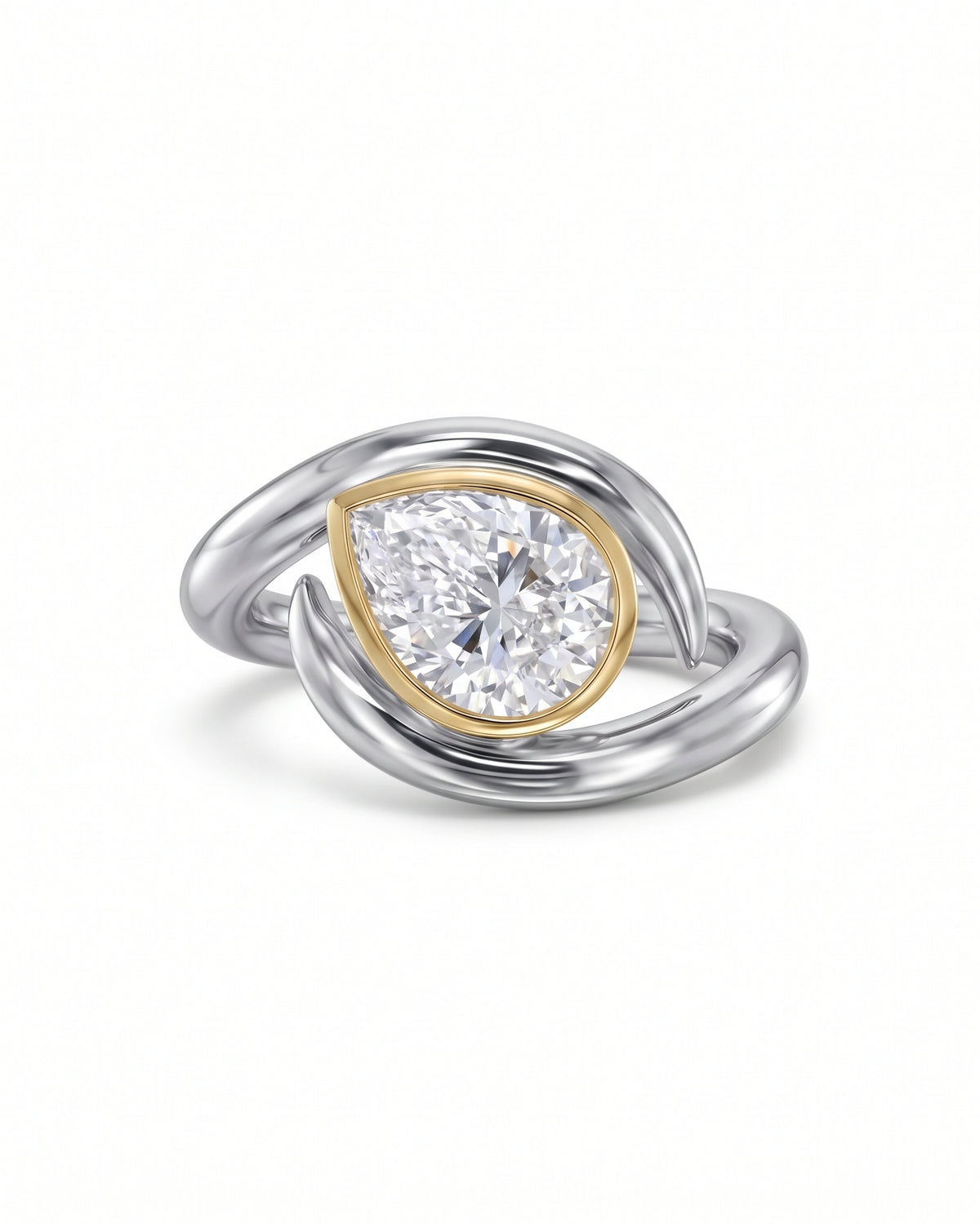 Pear cut diamond engagement ring with a gold bezel setting on a silver spiky bypass band.
