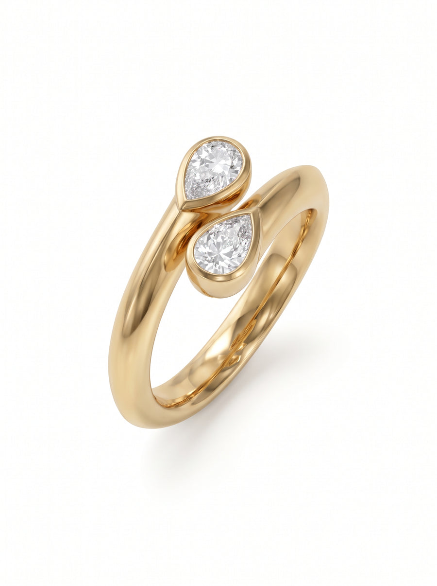 Gold toi et moi engagement ring featuring two pear-cut diamonds in a bypass setting.