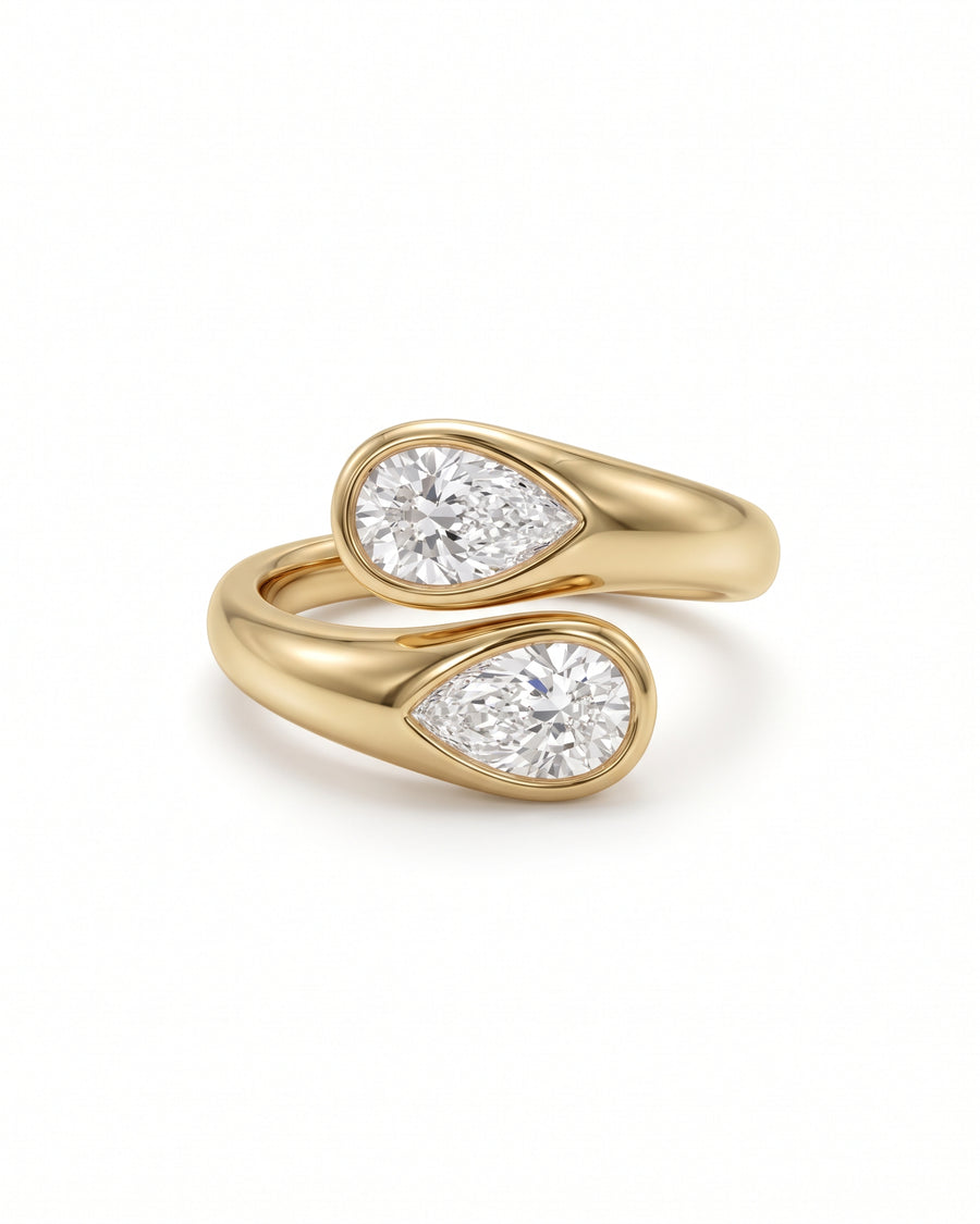 Gold toi et moi engagement ring featuring two pear-cut diamonds in bezel settings.