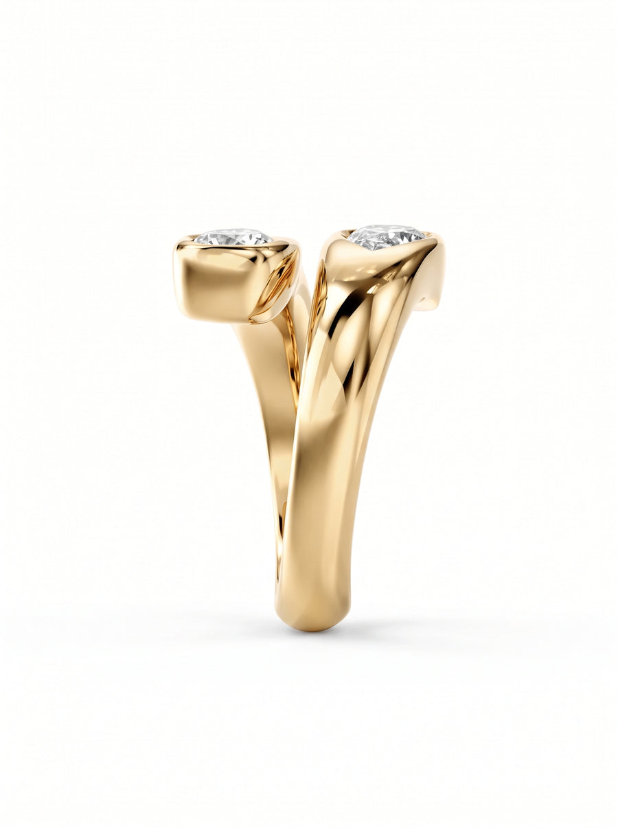 Gold toi et moi engagement ring featuring two pear-cut diamonds in a bypass setting.