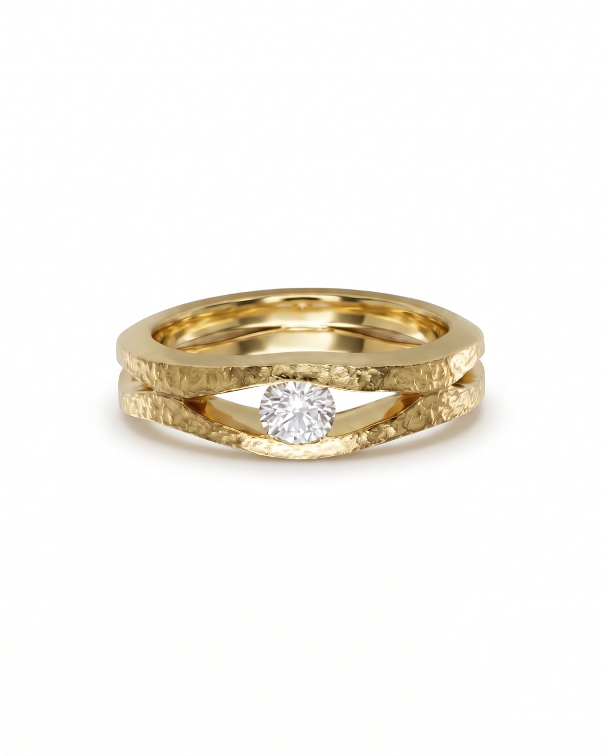 Gold solitaire ring with a hammered texture and a round diamond set between two split bands.