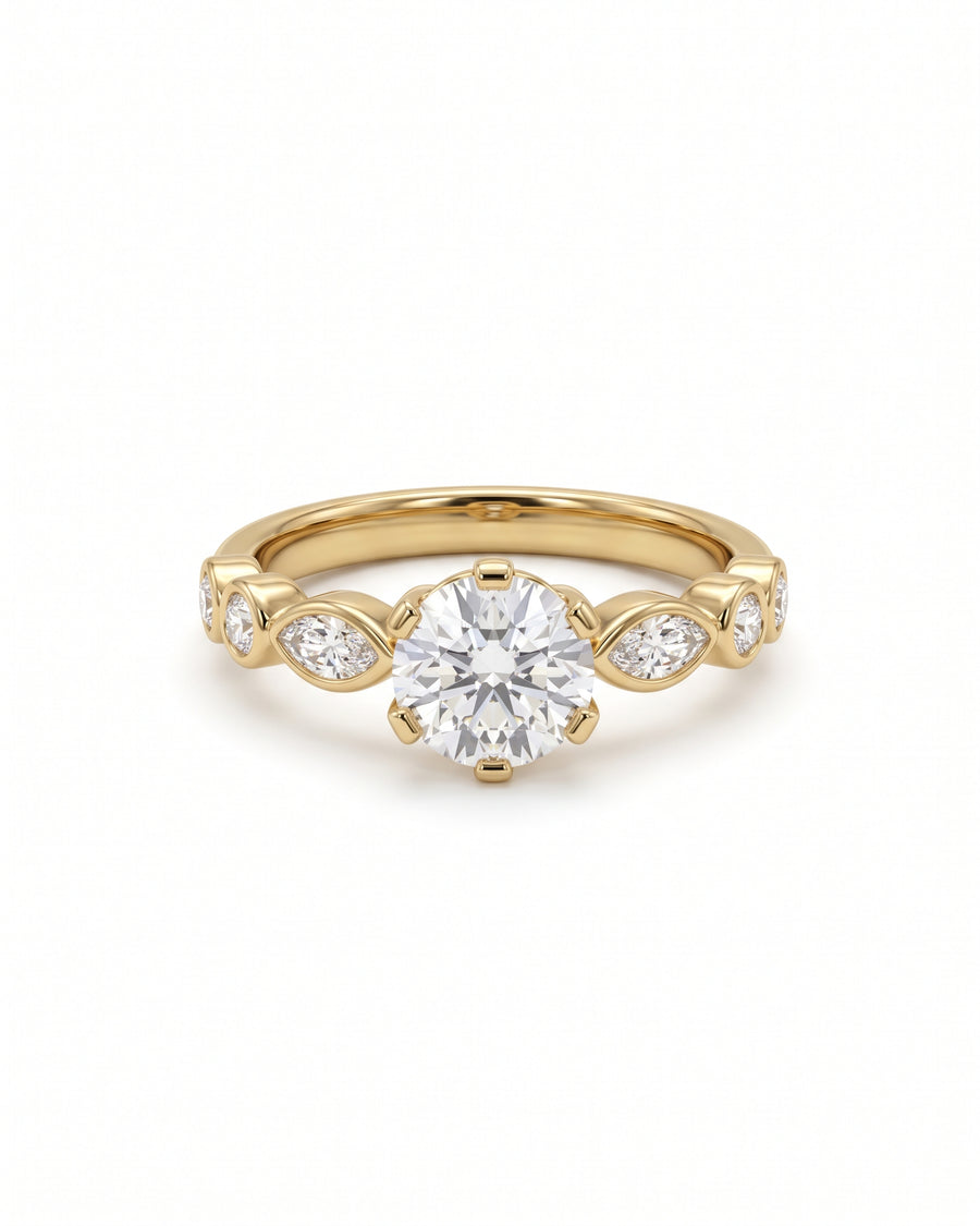 Round cut diamond engagement ring in 14k yellow gold with marquise and round side stones in a crown setting.
