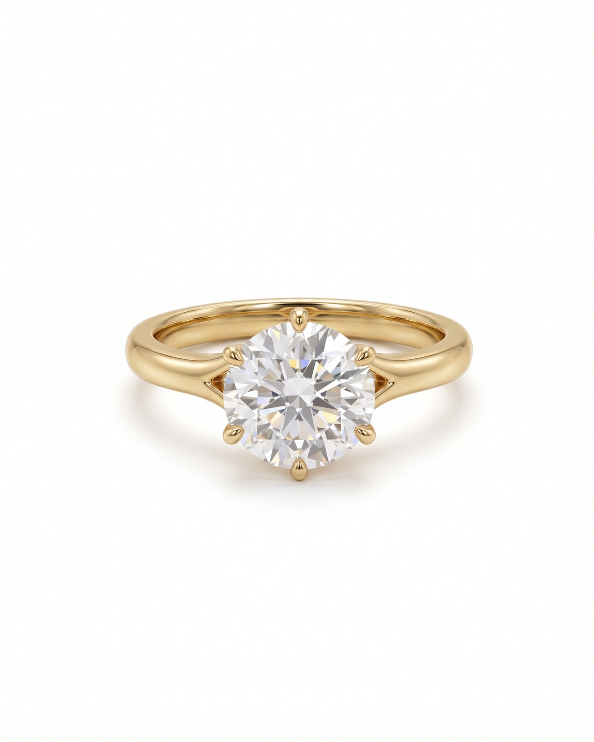 Round cut diamond engagement ring in 18k yellow gold with a six-prong tulip claw setting.