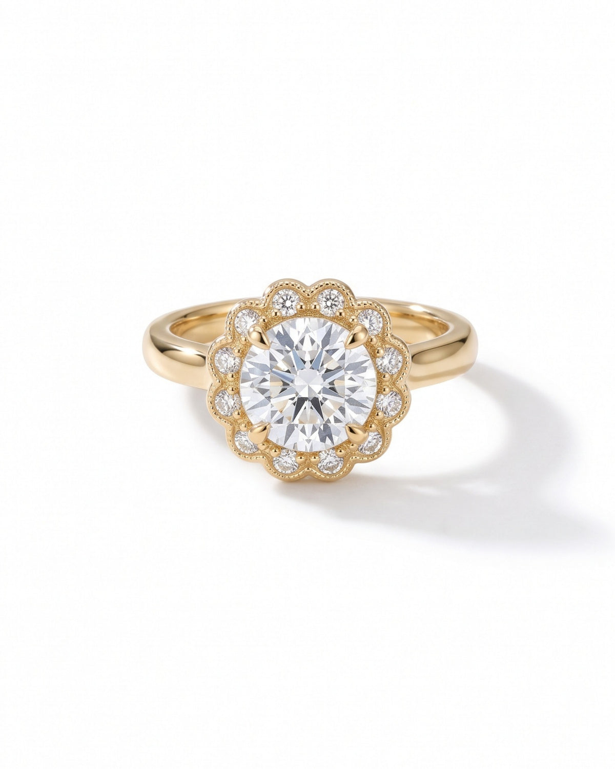 Gold engagement ring with a round diamond center stone surrounded by a scalloped diamond cluster halo.