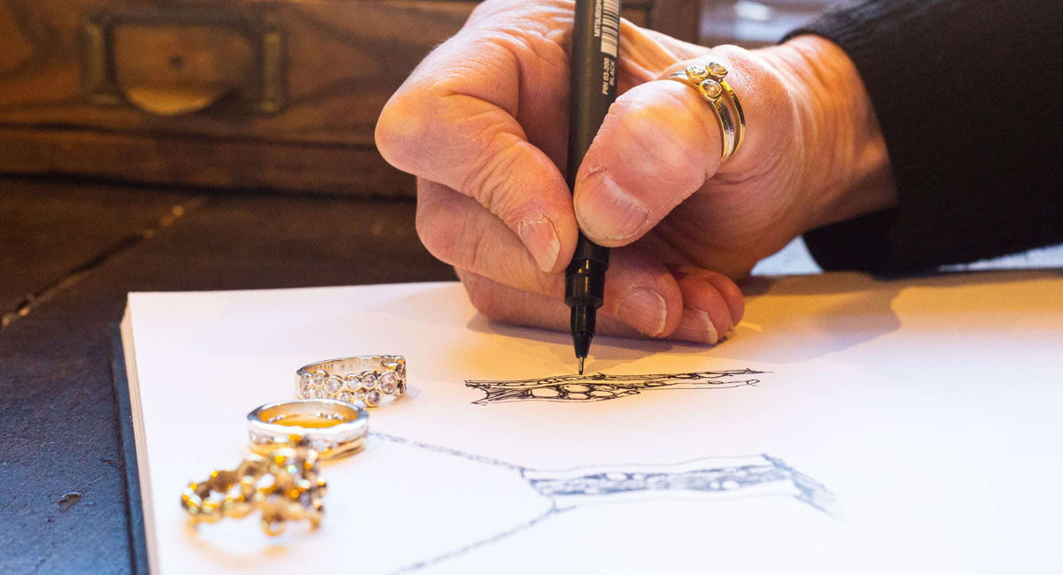 Designing jewellery by hand in a sketch book