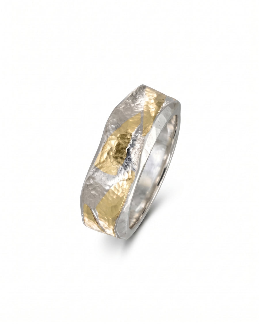 Flat ring in silver and gold with a hammered texture and wavy side design.