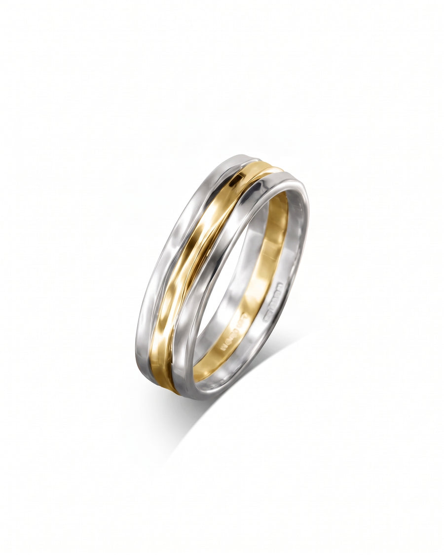 Three-strand ring featuring a central hammered gold band flanked by two polished silver bands.