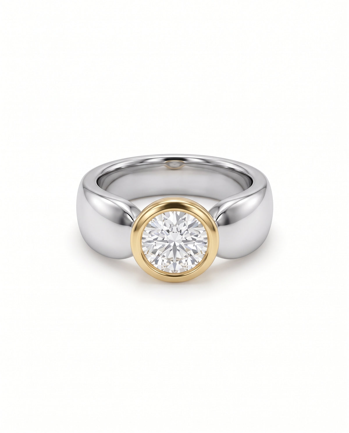 Round diamond solitaire engagement ring with a yellow gold bezel setting on a polished silver band.