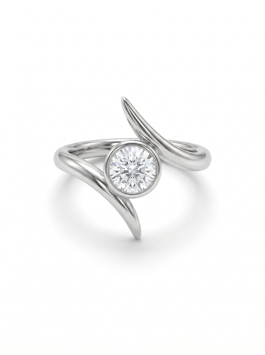 Silver engagement ring with a round bezel-set diamond and a unique crossover spiky band design.