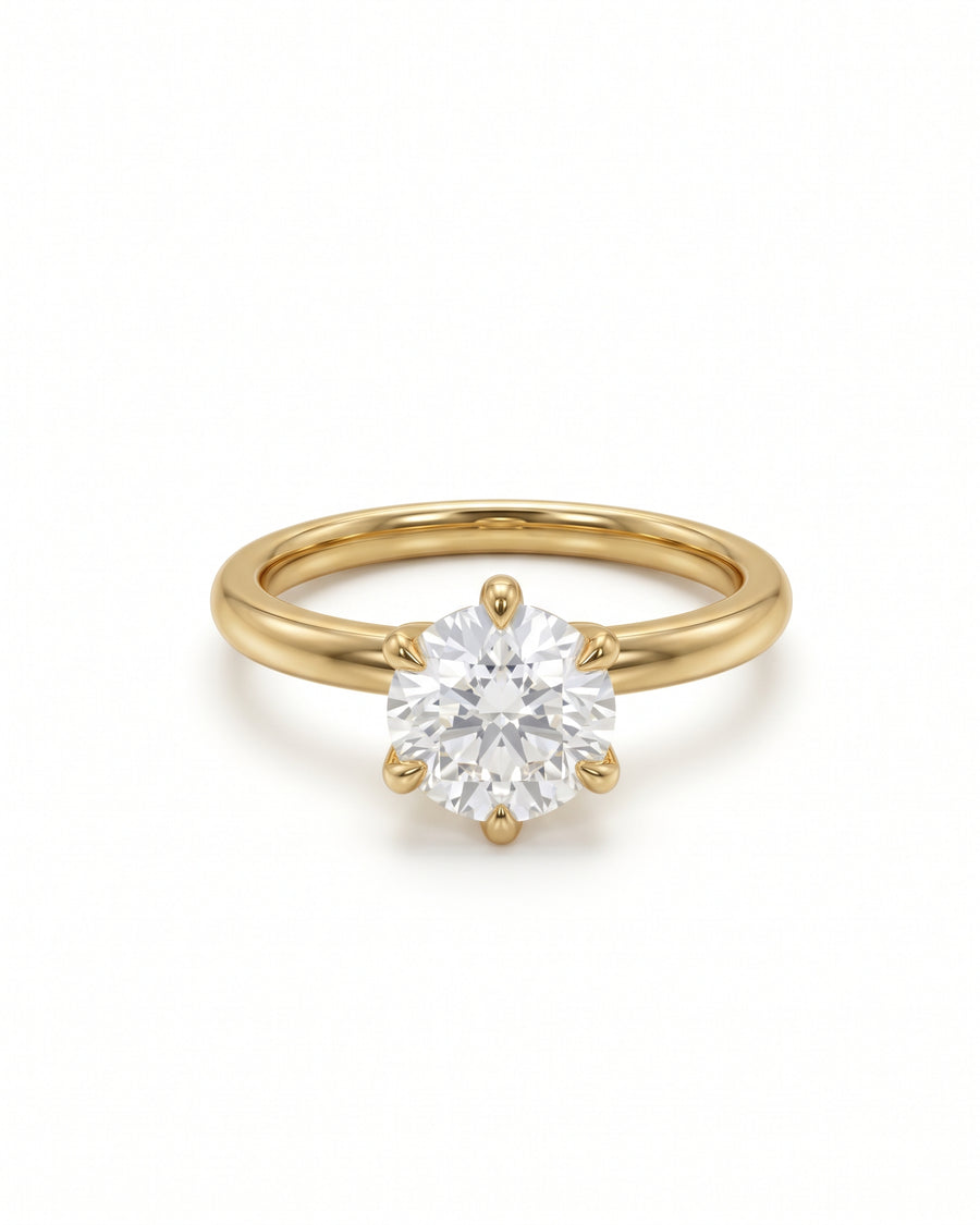 Round cut solitaire diamond engagement ring set in a polished yellow gold band with six prongs.