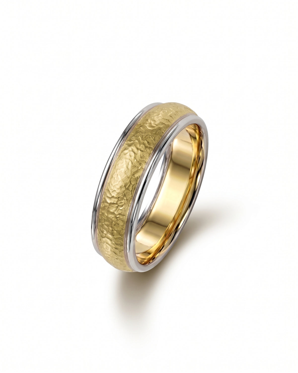 Two-tone wedding band featuring a hammered matte gold center with polished silver edges.