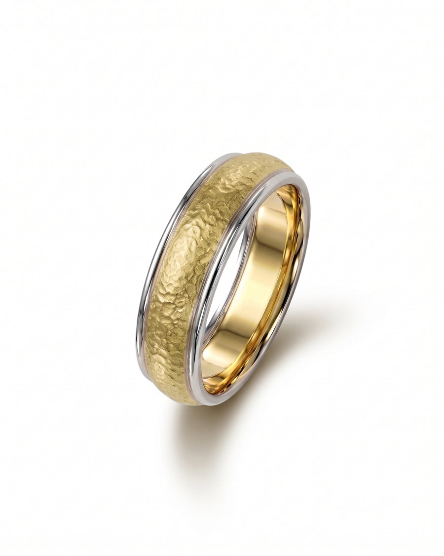 Two-tone wedding band featuring a hammered matte gold center with polished silver edges.