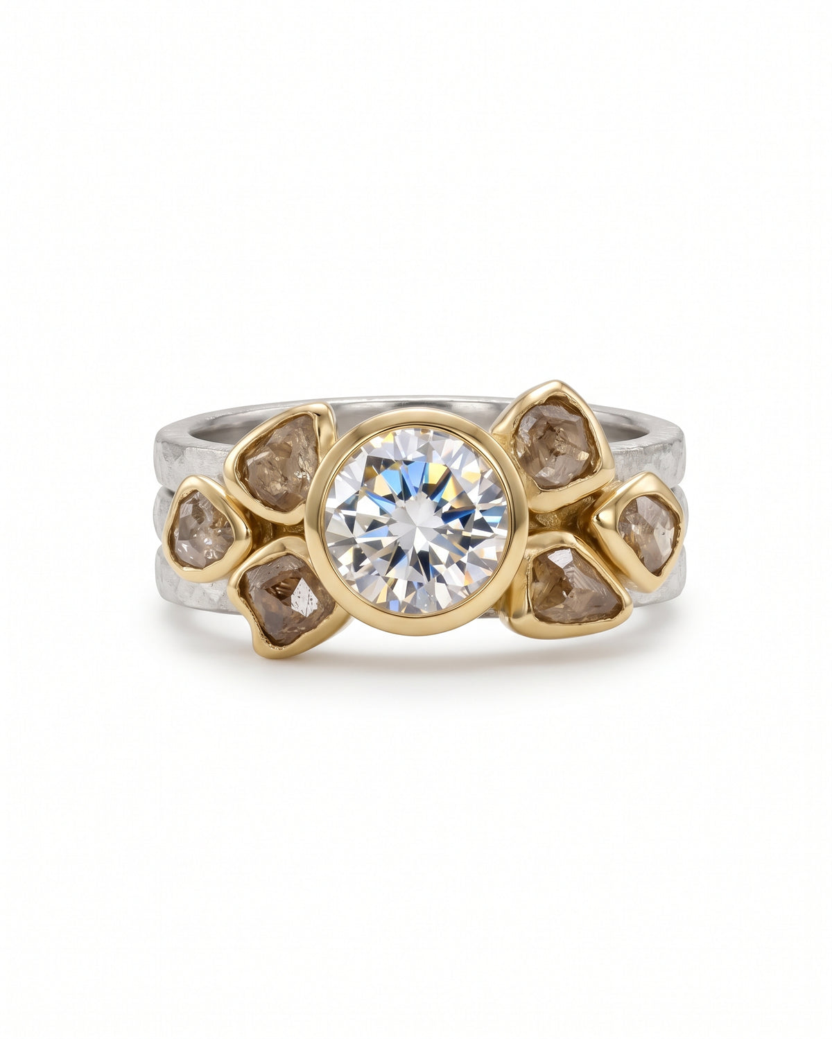 Two-tone gold and silver engagement ring featuring a round brilliant diamond surrounded by raw brown diamonds.