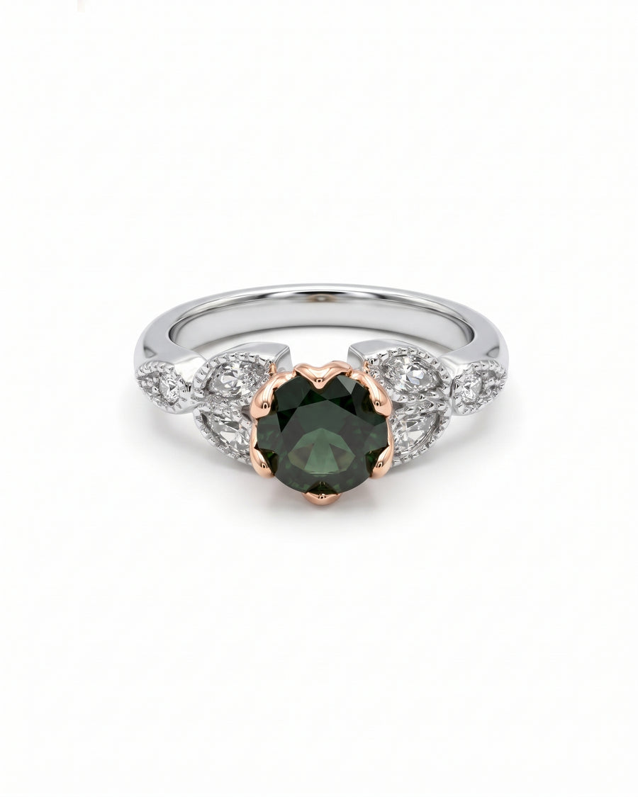 Round green diamond engagement ring in a rose gold setting with white gold and diamond leaf accents.