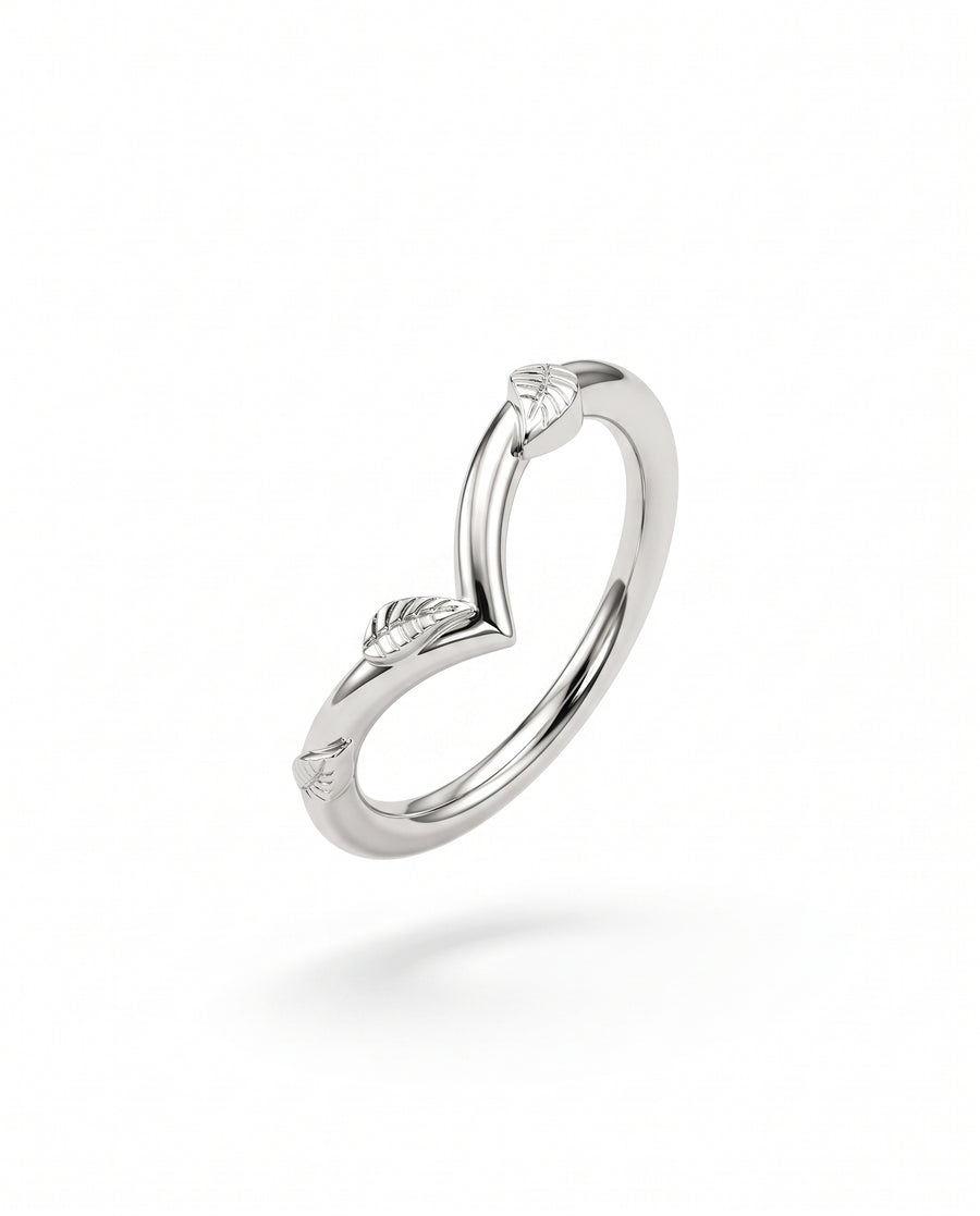 Silver wishbone wedding ring featuring engraved leaf details along the band on a white background.