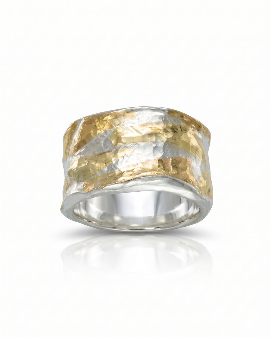 Wide band ring featuring a textured, hammered finish with alternating gold and silver metallic segments.