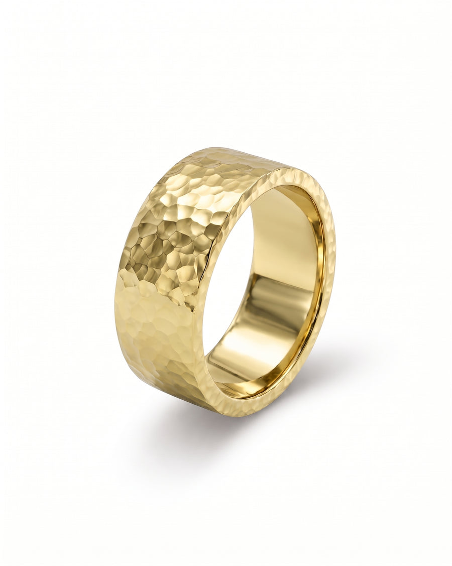 Gold flat wedding ring with a textured hammered finish and polished inner band.