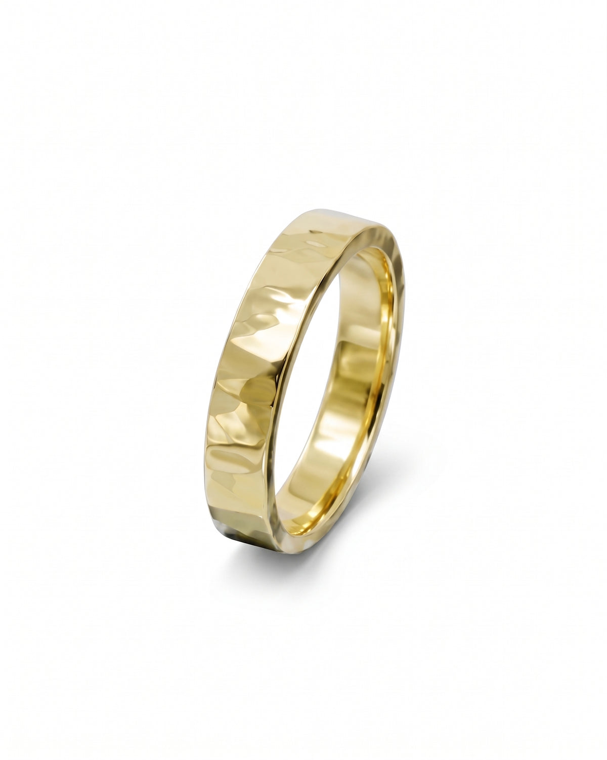 Gold wedding band with a hammered texture and polished finish isolated on a white background.