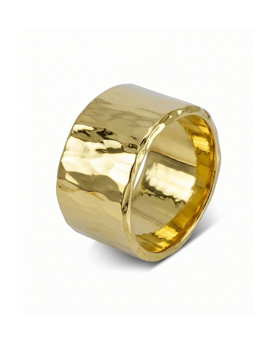 Wide gold wedding ring with a polished, hammered texture and a thick, rounded band design.