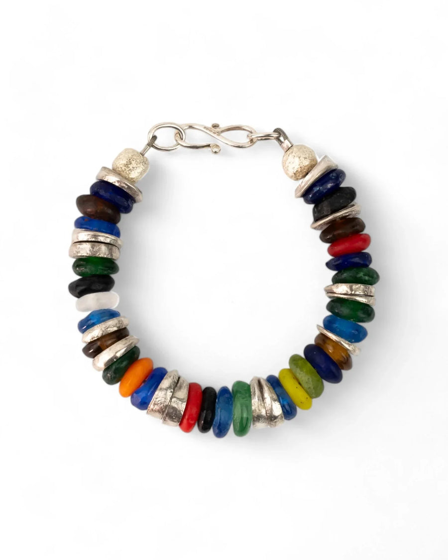 Colorful recycled glass bead bracelet with silver-toned spacers on white background