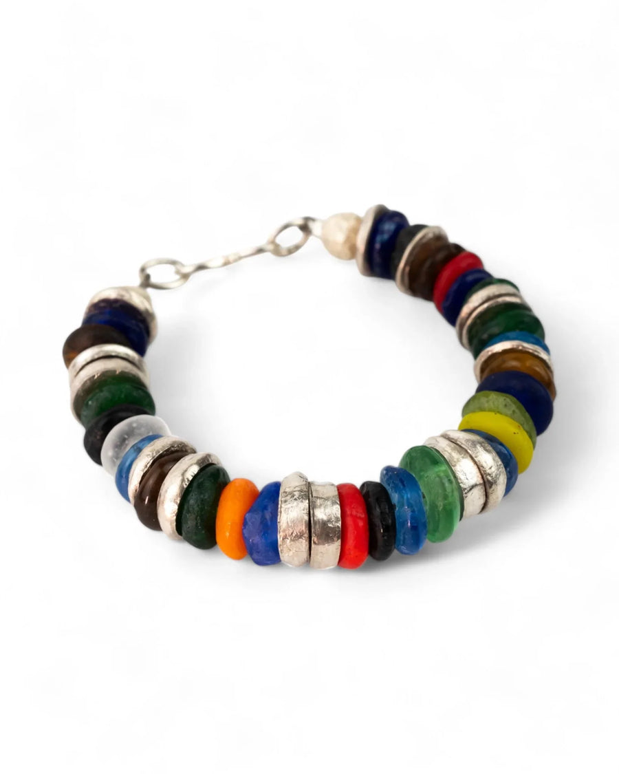 Colorful recycled glass bead bracelet with silver spacers on a white background