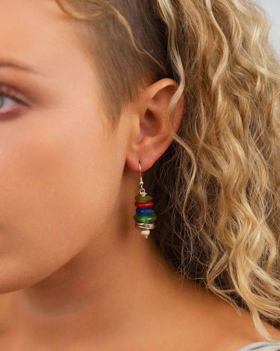 Handmade drop earring with stacked colorful recycled glass beads on ear