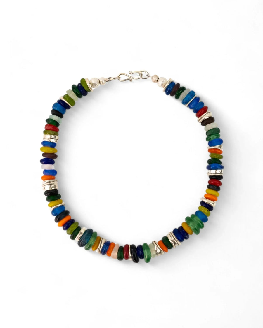 Handmade necklace with colorful recycled glass beads and silver accents on white background