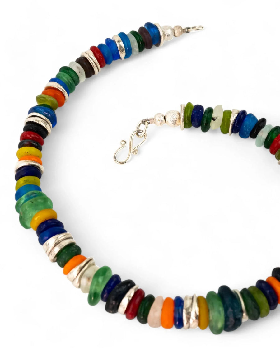 Handmade necklace with multicoloured recycled glass beads and silver spacers on white background