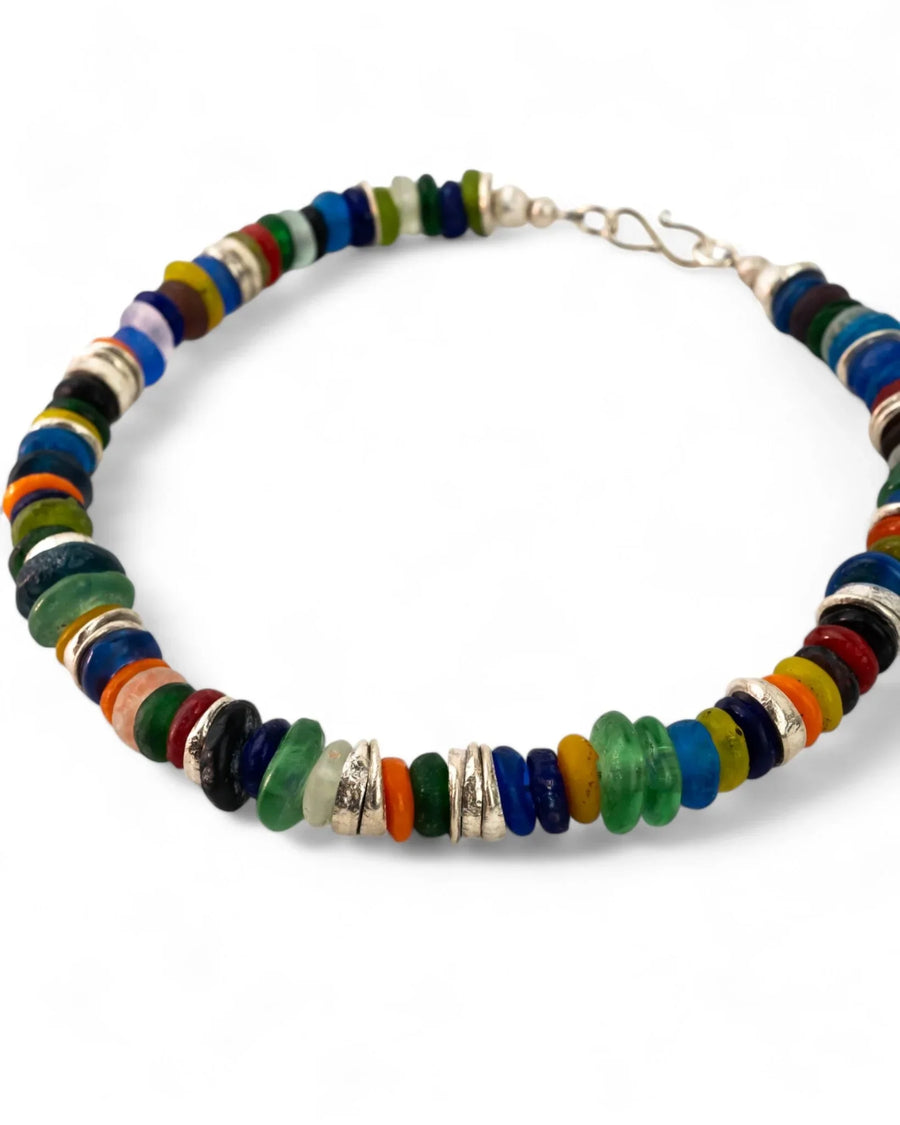 Colorful recycled glass bead necklace with silver spacers on white background