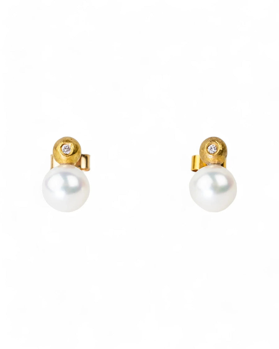 Gold stud earrings with white Akoya pearls and small diamond accents on white background