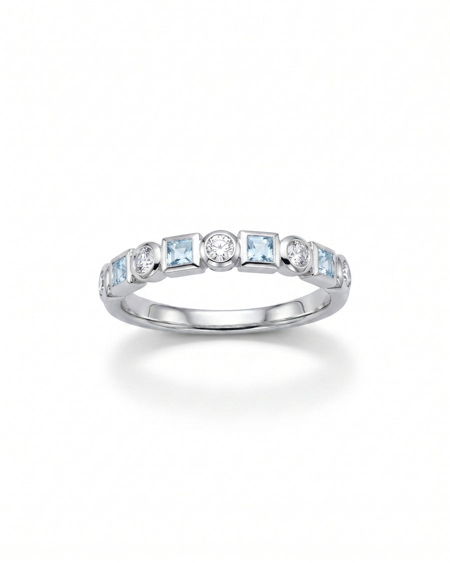 Platinum half eternity ring with alternating round diamonds and square aquamarines.