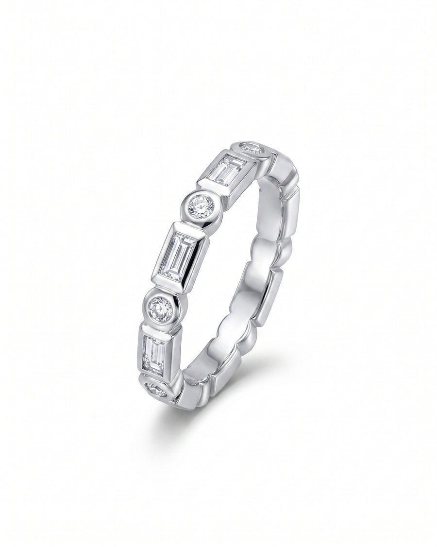 White gold eternity ring with alternating baguette and round diamonds.