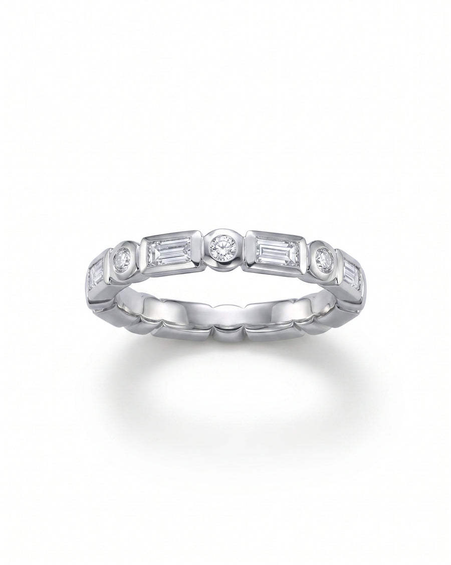 White gold eternity ring with alternating baguette and round diamonds.