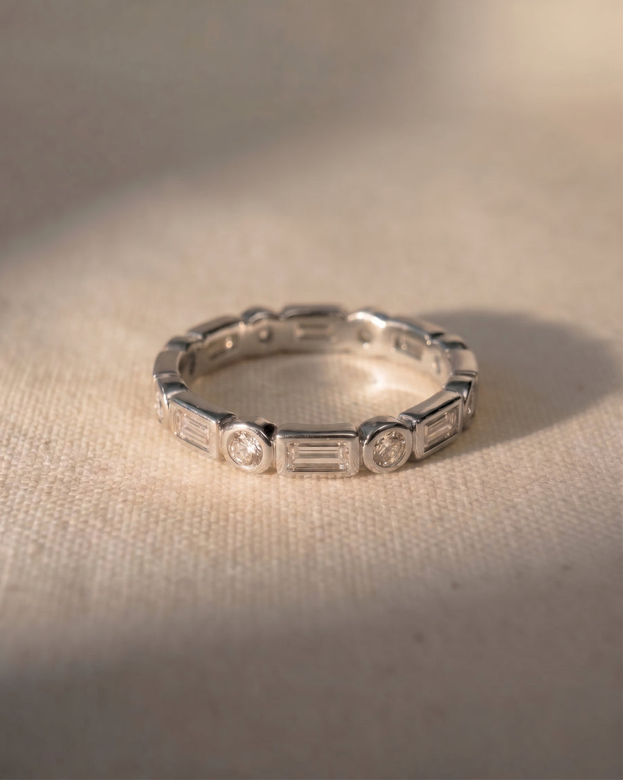 9ct white gold eternity ring with alternating baguette and round diamonds.
