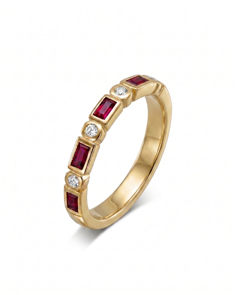 Yellow gold eternity ring with alternating baguette rubies and round diamonds.