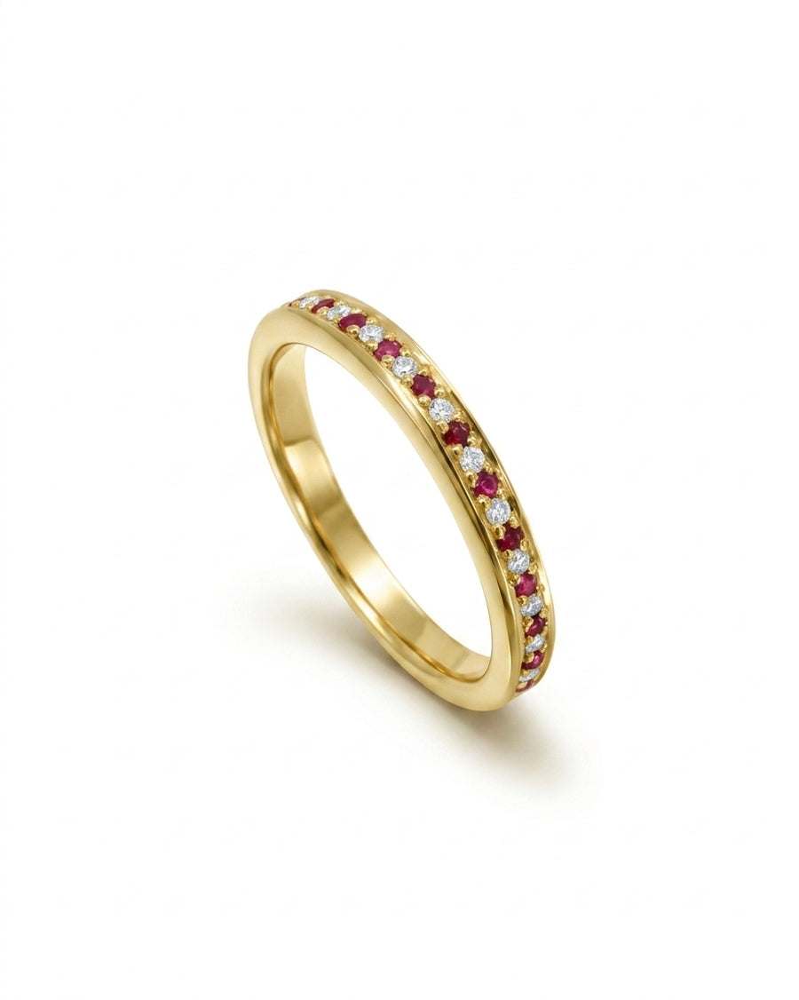 Gold eternity ring with alternating rubies and diamonds.